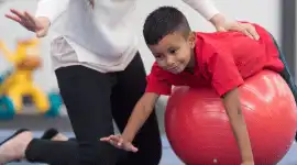 An occupational therapist working with a young child