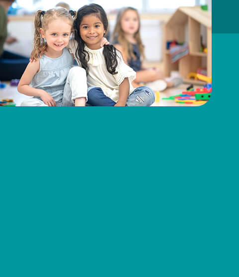 Preschool children sitting in classroom together