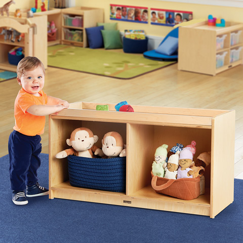 Toddler pulling up on storage shelf