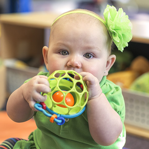 Infant playing with an Oball