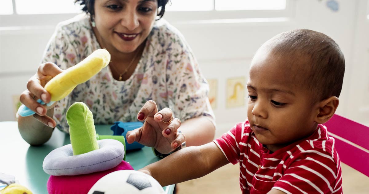 Child playing with teacher