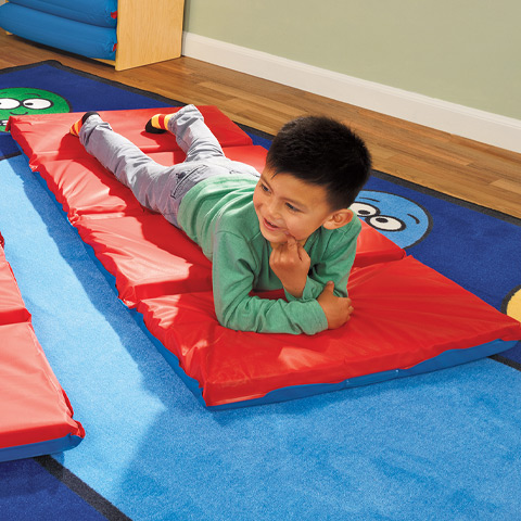 Preschool boy resting on Angeles rest mat