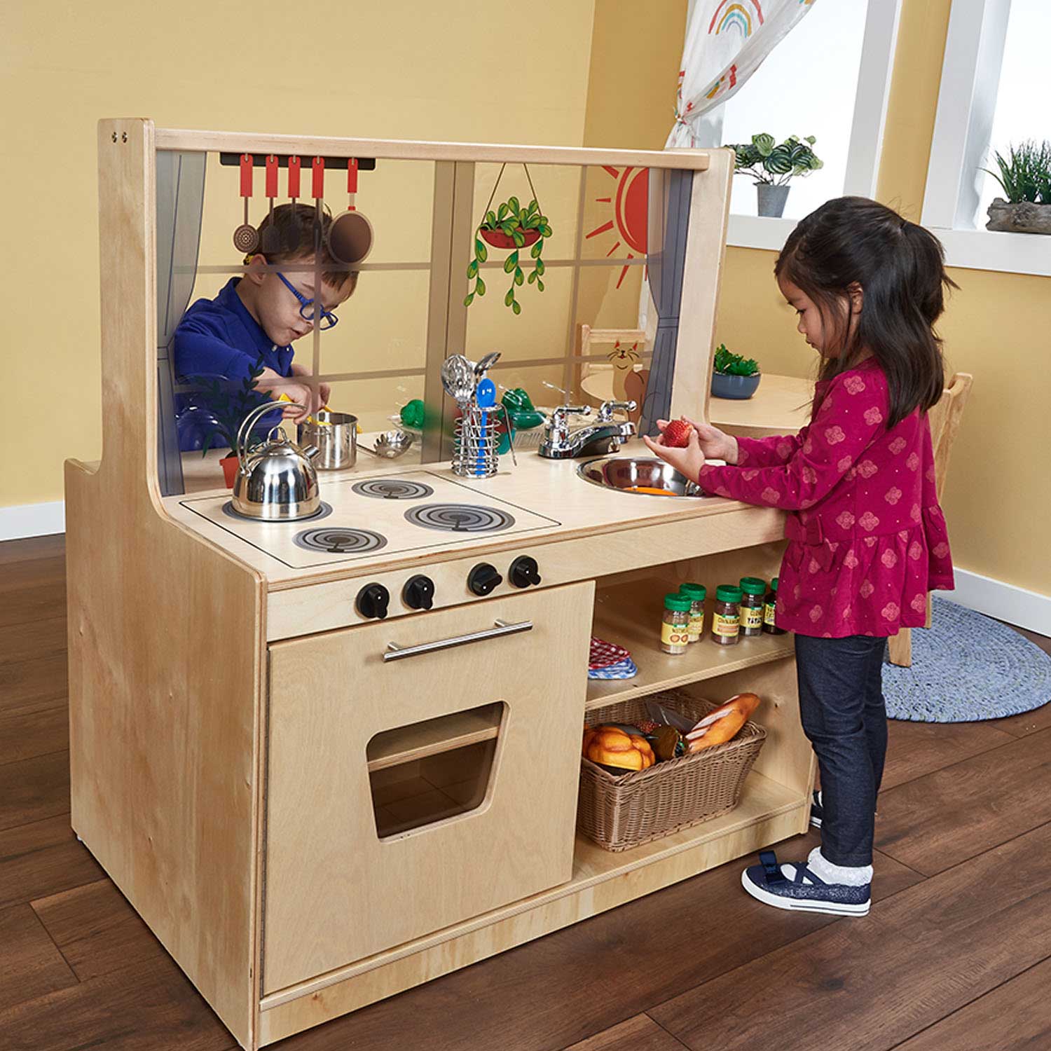 Preschool children playing with Becker’s Sunny Day Double-Sided Kitchen