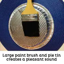 Metal pie tin and large paint brush