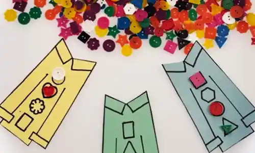 ​​​​​​Bright buttons and Pete the Cat shirt activity on white tray​