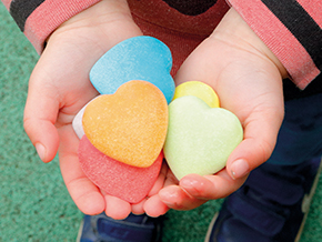 Child holding Yellow Door Kindness Hearts