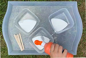 Pouring paint into bowls with glue