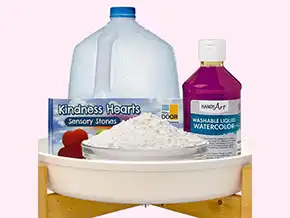 ​​Water, cornstarch, liquid watercolor, Kindness Hearts, and Tuff Tray for Becker’s ECE sensory activity.