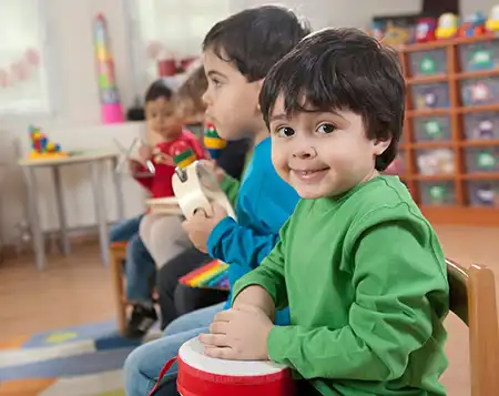 young children playing instruments in a classroom