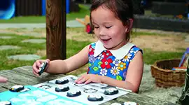 Girl playing with coding penguins