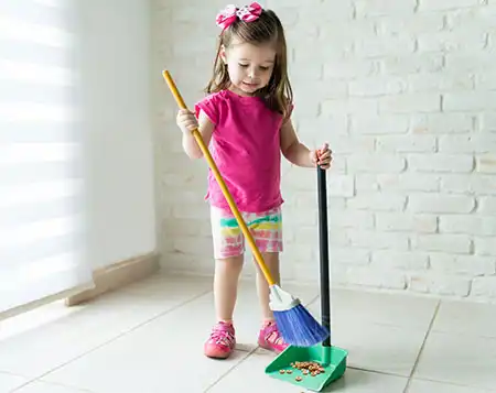 young child sweeping