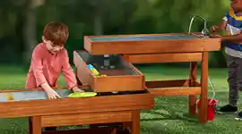 Children playing outside in sensory water table 