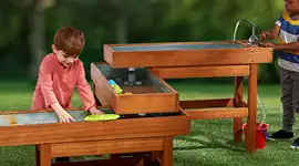 Children playing outside in sensory water table 