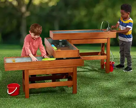 Children playing outside in sensory water table