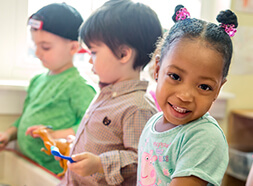 Preschool children playing at sensory table