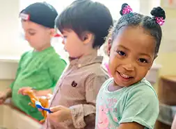 Preschool children playing at sensory table