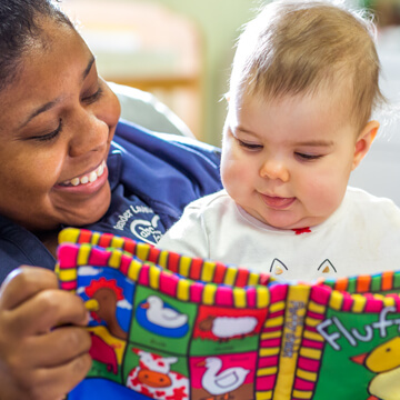 Teacher reading to an infant