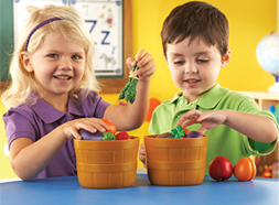 Preschool children in classroom playing with Sprouts Bushel of Fruit