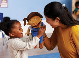 Teacher and preschool child playing with MVP Puppet