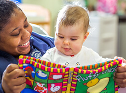 Teacher reading to an infant