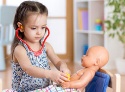 Preschool child playing with a doll