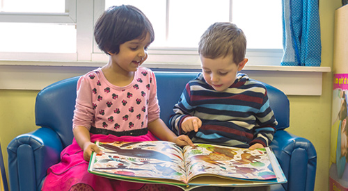 Preschool teacher reading to children